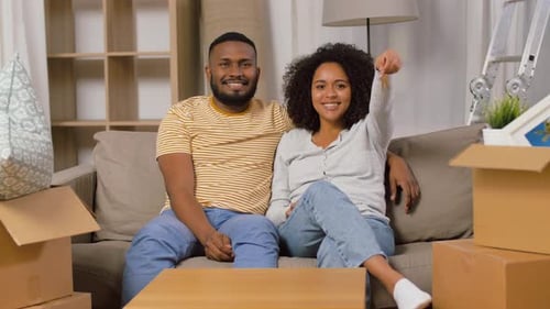 Mortgage, Eco Living And Real Estate Concept - Happy African American Couple With House Key And B...