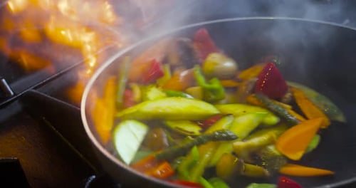 Vegetables Sautéing in Frying Pan Over Gas Stove