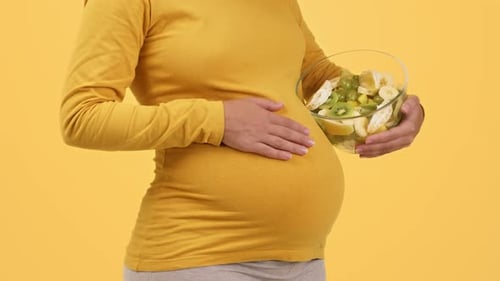 Pregnant Woman Holding Fruit for Healthy Eating