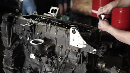 Mechanic Working on Large, Complex Engine