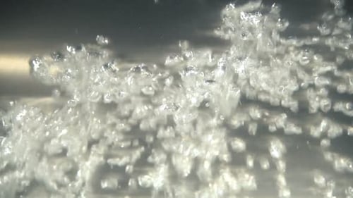 Boiling noodles lift bubbles in slow motion close up kitchen preparation