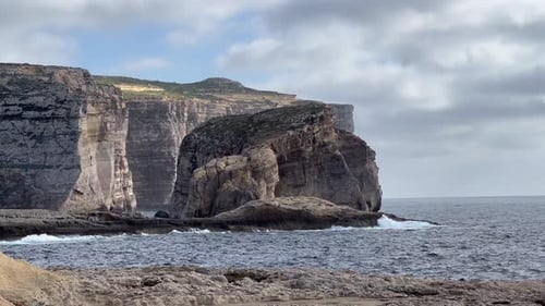 4K Handheld Shot Capturing the Rustic Shoreline Beauty of Dwejra Bay, Gozo Island, Malta: Waves of t