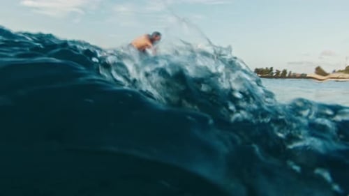 Male Surfer Surfs the Ocean Wave at Sunrise Underwater Footage of the Surfer