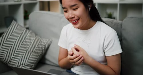 Smiling Woman Video Calling at Home on Laptop