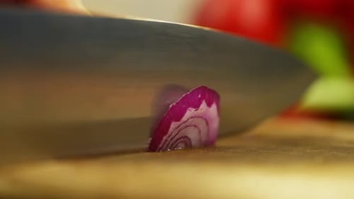 Chef Slicing Purple Onion in Kitchen Close Up