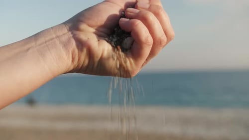 Woman Hand with Stones on the Beach Background Close Up Macro Summer Shot for Travel Business Nature