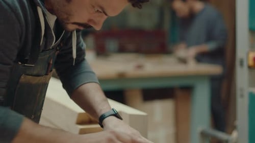 Woodworker Polishing Wooden Craft in the Workshop