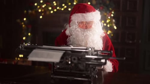 Santa Claus Typing on Vintage Typewriter at Desk