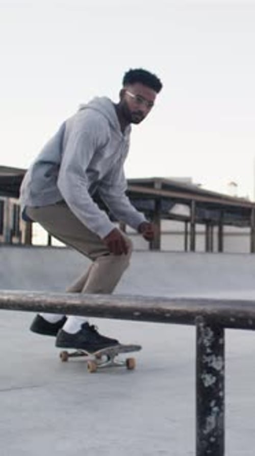 Man, city and action with skateboard for grind on rail with trick, training and jump for sports