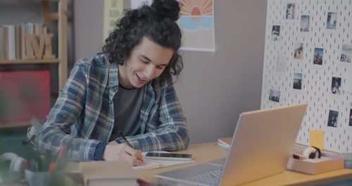 Young Adult Participating in a Video Call at Desk
