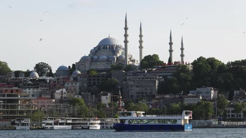 Scenic view of the waterfront with a mosque and cruise boats on the Bosphorus in Istanbul