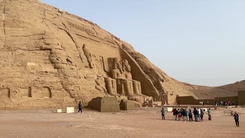 PHARAOH RAMSES II STATUE IN HIS THRONE, LEFT SIDE VIEW. TEMPLE IN EGYPT IN THE VILLAGE OF ABU SIMBEL