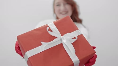Cheerful Woman Giving Christmas Gift