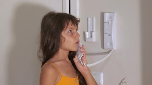 Girl Talking on the Intercom Inside