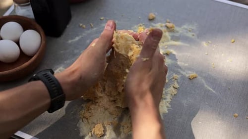 Hands Kneading Dough on a Table