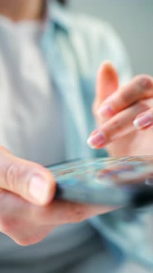 Woman Scrolling Through Social Media Feeds on Smartphone Close Up