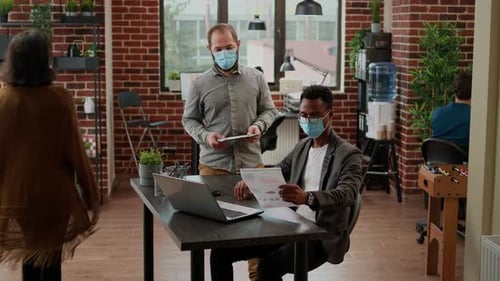 Colleagues Collaborate in Modern Office Setting