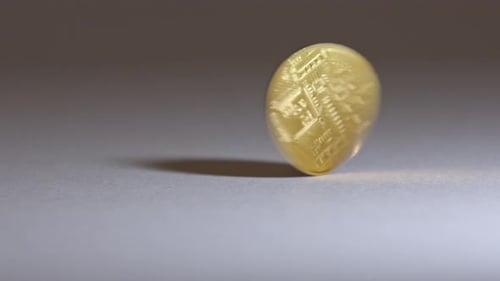Bitcoin spinning, gold reflection
