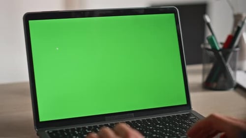 Unknown Freelancer Working Green Screen Laptop in Modern Workplace Closeup
