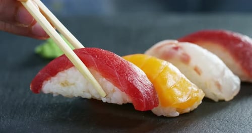 Macro shot of sushi, sashimi, uramaki and nighiri. typical Japanese dish consisting of rice, salmo