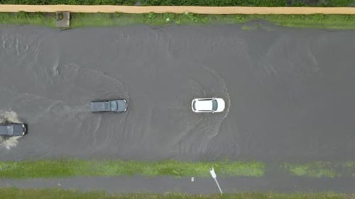 Aerial View of City Traffic with Cars Driving on Flooded Street After Heavy Rain