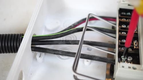 Tightening Electrical Wires in Junction Box With Screwdriver