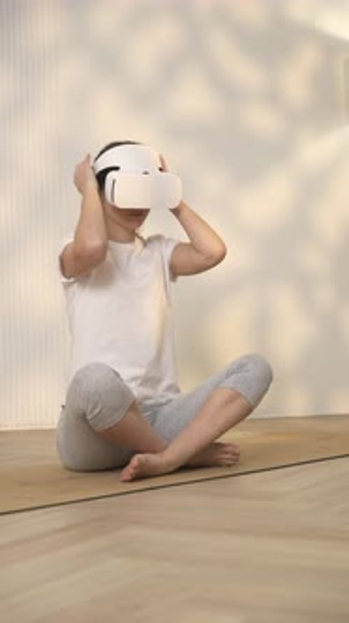 Woman Using VR Headset Sitting in Lotus Position