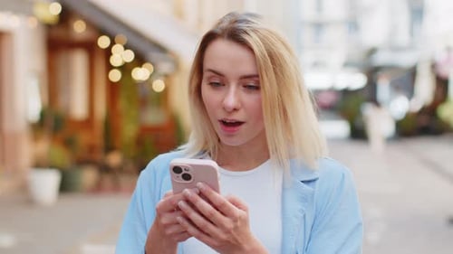Young Woman Reacts Happily to Phone News