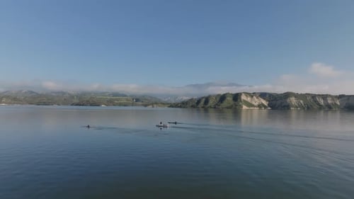 Aerial View of Boats of Water Surface Two Rowing Sportsmen and Coach on Motorboat Large Lake and