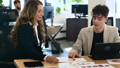 Business Professionals Reviewing Charts in Office