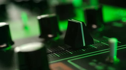 Hand Adjusting Slider on a Music Synthesizer Board