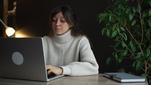 Woman Working on Laptop Showing Shocked Expression