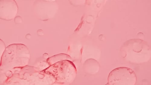 Slow Motion of Moving Yellow Pink Oil Air Bubbles in Water Rising Up on Light White Background