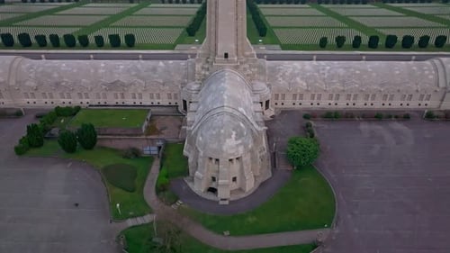 Aerial view of drone flying across Douaumont Ossuary at sunset