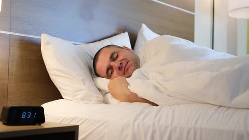 Happy Man Sleeping Peacefully in Bed