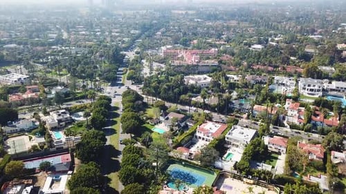 Traffic on junction in Beverly Hills Neighborhood. Sunny day with luxury villas and mansions in rich