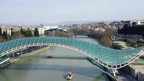People gathered on a beautiful bridge with glass roof, futuristic architecture, 4k