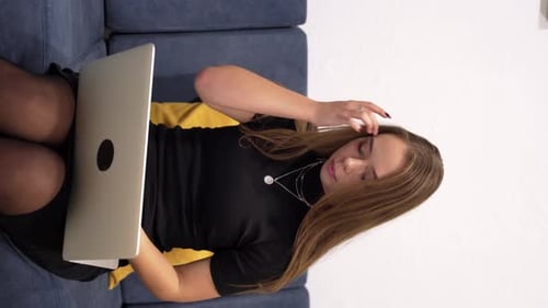 Vertical Shot of Young Female Freelancer Works Remotely