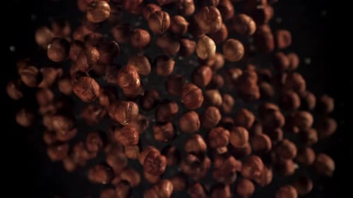 Hazelnuts Rotating and Floating on a Black Background
