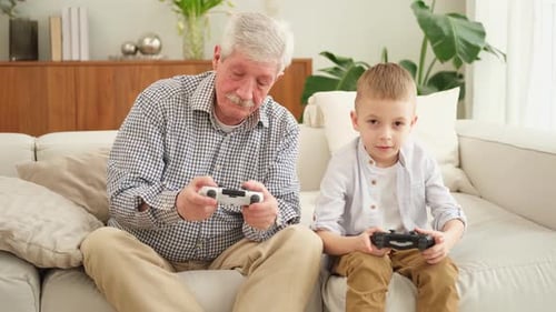 Grandfather and Grandson Play Video Games Together