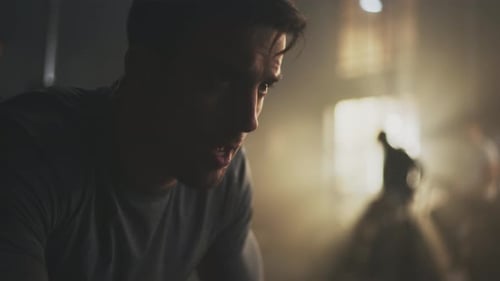 Focused Man Training in Dark Urban Gym