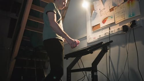 Man Walking Through Backstage Area Near Technical Control Panel and Notes Board