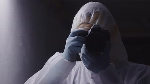 Crime investigator photographer using camera, front middle head shot, copyspace