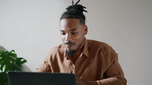 Young Man at Computer Talking on Video Call