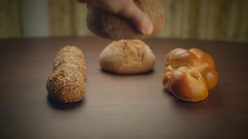 An Assortment of Freshly Baked Bread Loaves Displayed Elegantly on a Vintage Wooden Table