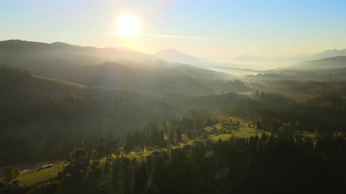Wooded Hills of Carpathian Mountains in Ukraine with Small Traditional Village Houses at Sunset