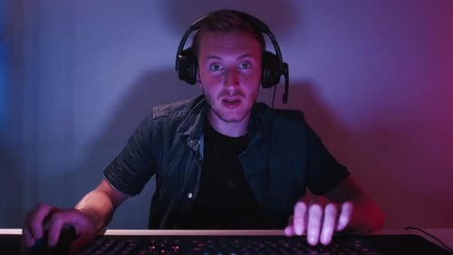 Excited Young Gamer Playing Video Game at Night