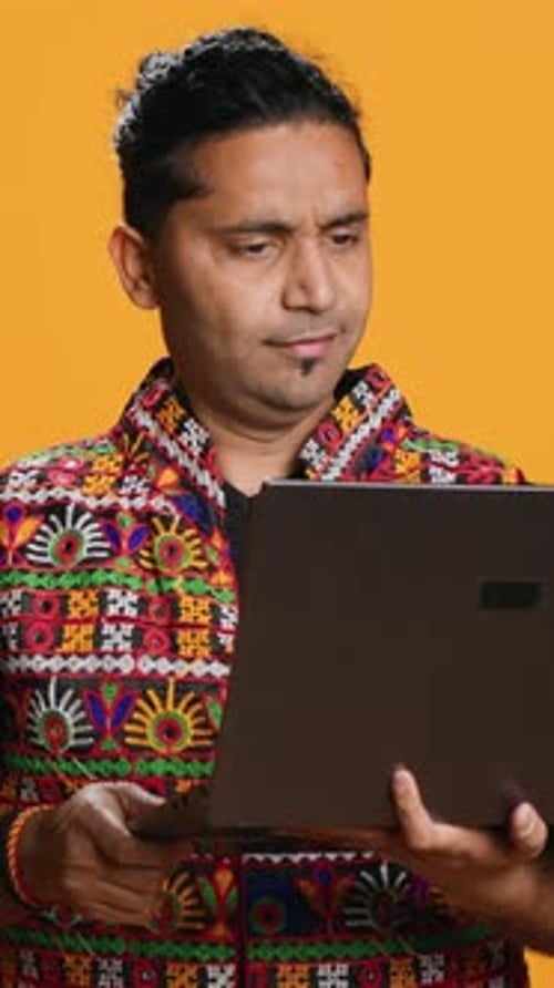 Vertical Video Man with Friends in Teleconference Meeting Using Laptop Studio Background