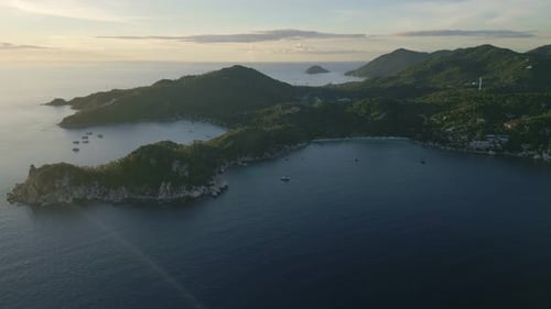 Stunning sunset aerial over Koh Tao, featuring the island’s coastline and turquoise waters with a pe