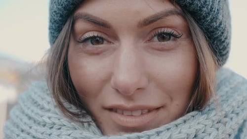 Smiling Woman Wearing a Beanie and Scarf
